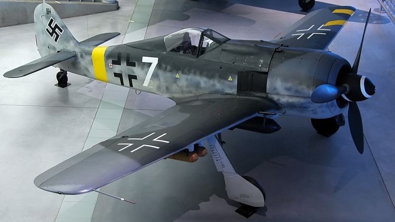 A German Focke-Wulf Fw 190 on display in a museum, with a white spiral painted on its nose cone.