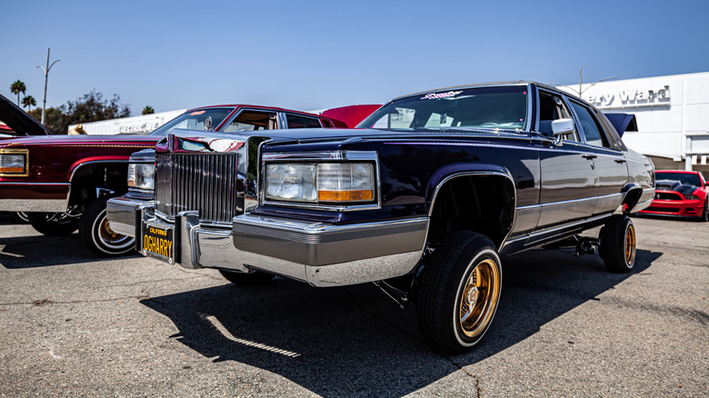 Lowrider Cadillac with gold wheels at a Los Angeles car meet