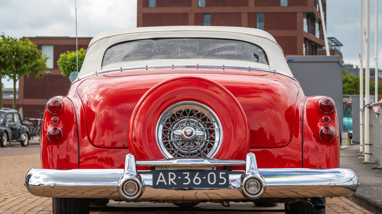 A red and silver chromium-colored vintage car.
