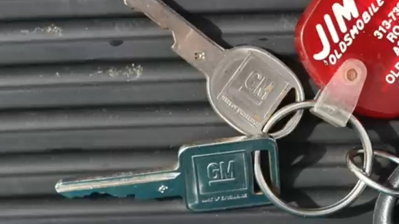 A set of GM keys with a square and round keys.