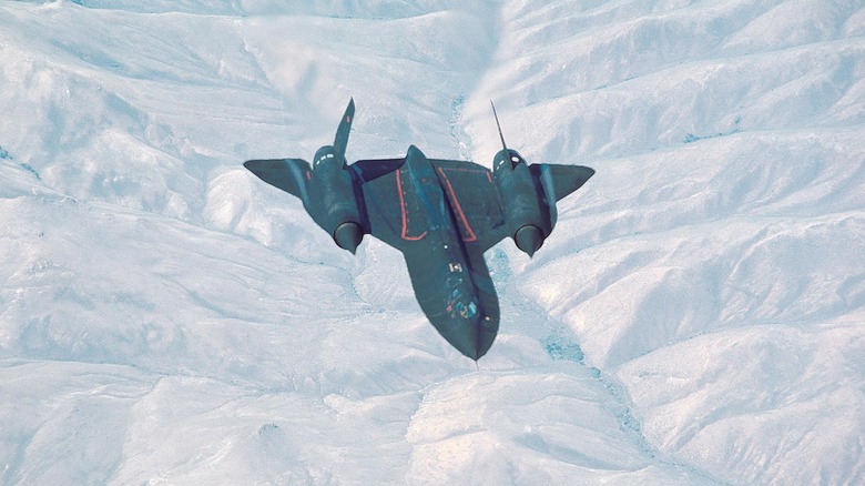 SR-71 Blackbird flying over snow capped mountains