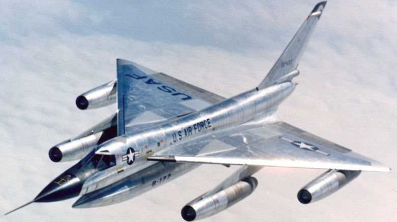 A Convair B-58 Hustler flying high over clouds.