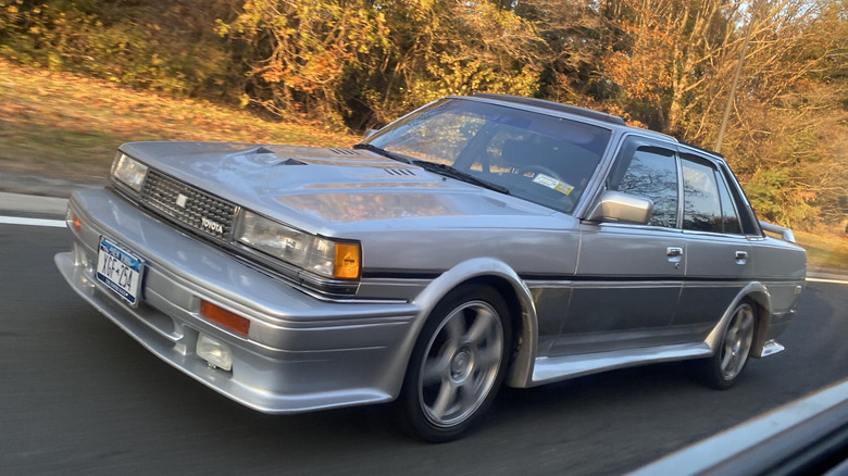 modified toyota cressida speeds down the road