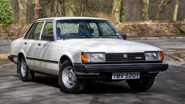 a white 1982 toyota cressida in the british countryside