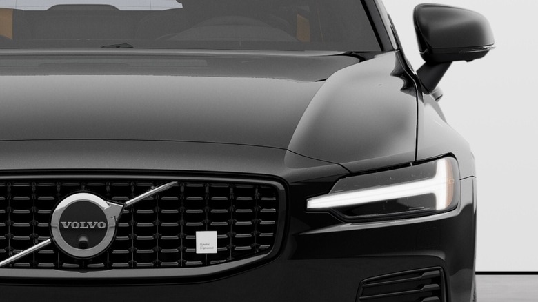 Front of a black V60 Polestar Engineered plug-in hybrid wagon showing the grill and headlights