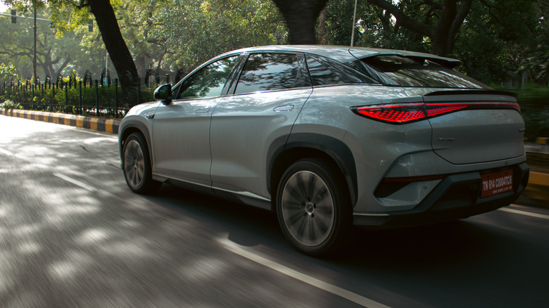 A BYD crossover on the move, rear 3/4 view