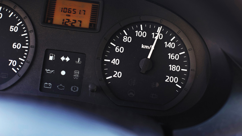 Car speedometer needle hitting the 120 mph mark