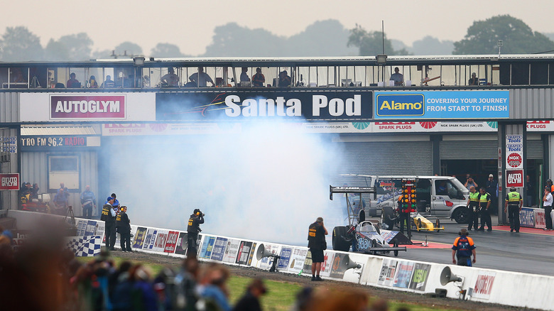 Top fuel dragster doing burnout on track