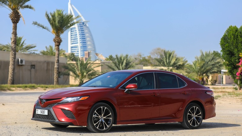 A Toyota Camry hybrid parked on a street in Dubai.