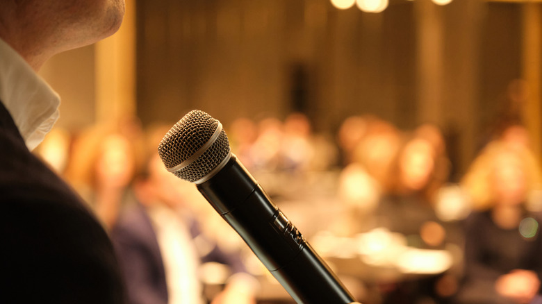person standing in front of a microphone