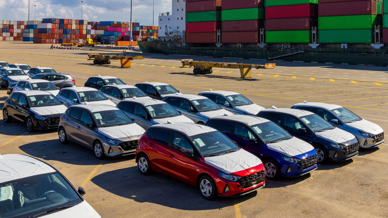 New imported cars covered in protective plastic await delivery from the docks