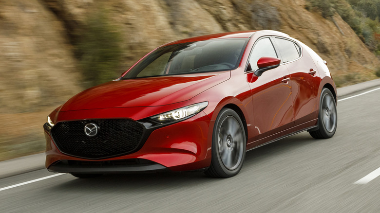 Red 2019 Mazda3 hatchback on mountain road