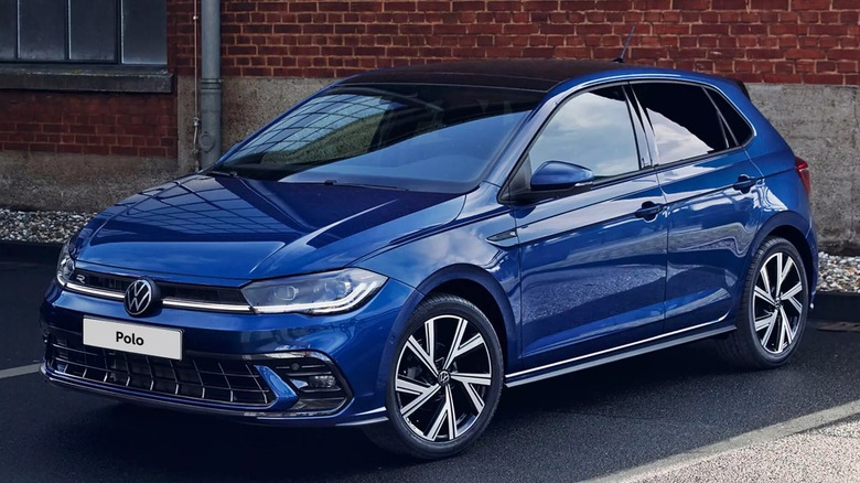 Blue volkswagen polo in parking lot from front left