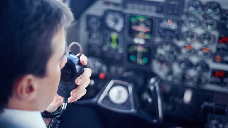 airplane pilot using handheld radio