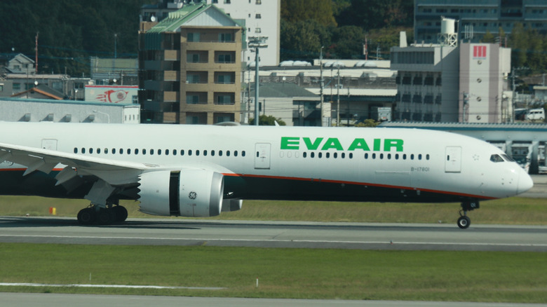 Thrust reversers engaged on landing Eva Air Boeing 777-300 ER, right-side view