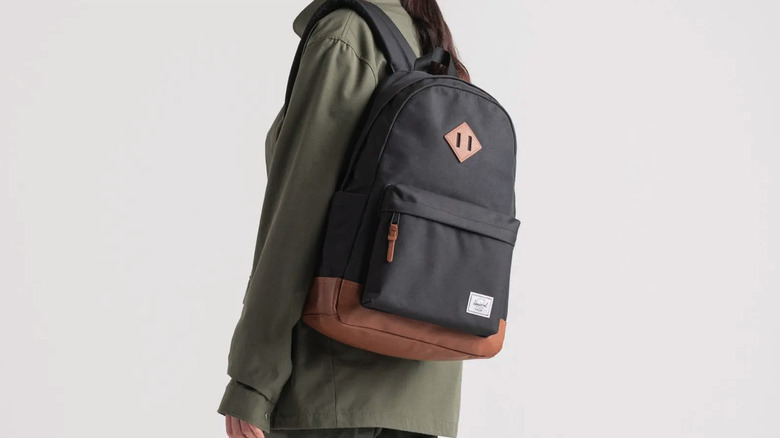 Person wearing black and brown Herschel Heritage Backpack