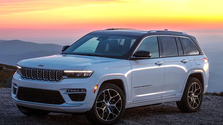 Jeep Grand Cherokee parked on a hill at sunset
