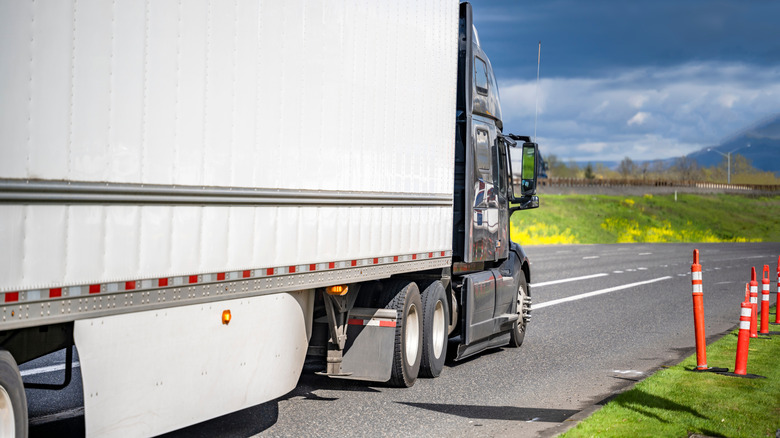 Side view of semi-truck trailer showing side skirt