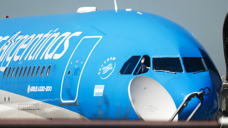 co-pilot waving through open cockpit window of Airbus A330