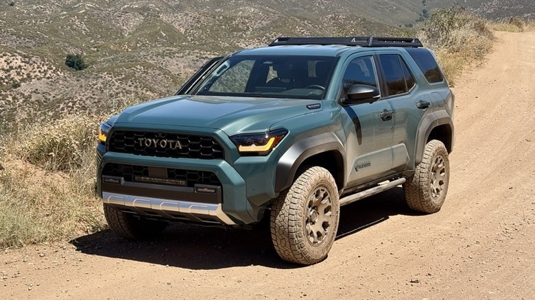 Front view of a green 2025 Toyota 4Runner parked on an dirt trail