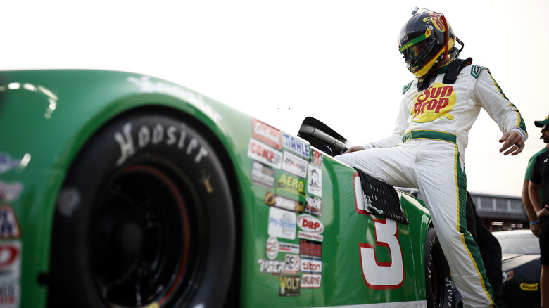 NASCAR driver entering race car without doors