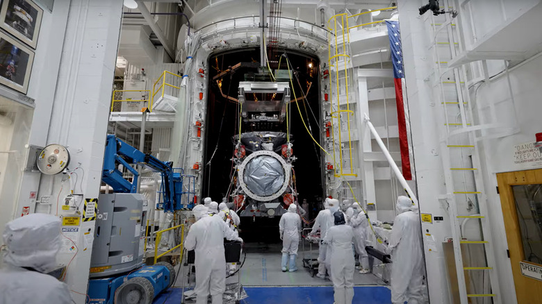 NASA scientists angle the famed Europa Clipper into the 25-foot space simulator for environmental testing.