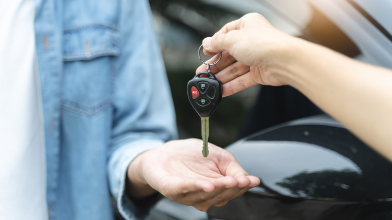 Person being handed car key