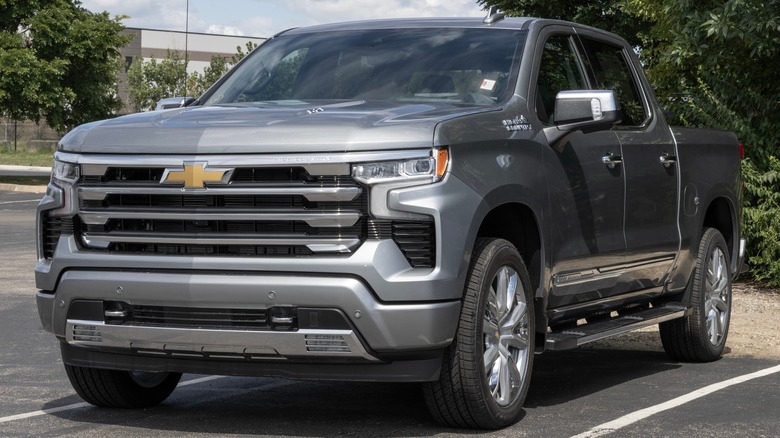 A silver Chevy Silverado 1500 in a parking lot.