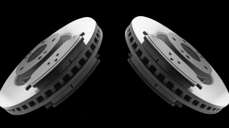 Two ventilated brake discs against a black background