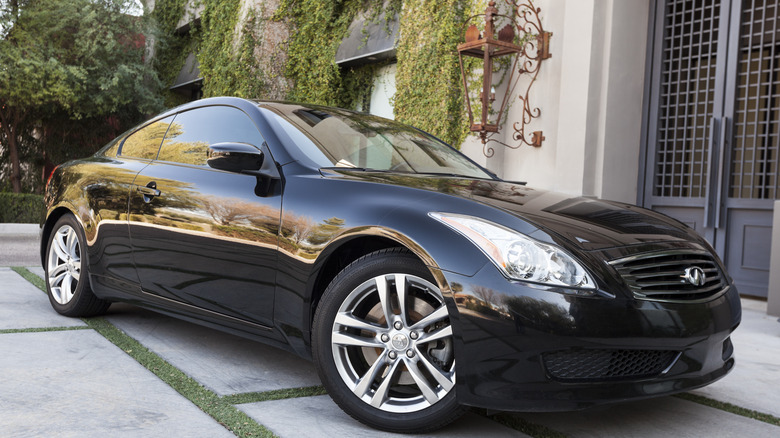 Black Infiniti coupe parked in driveway