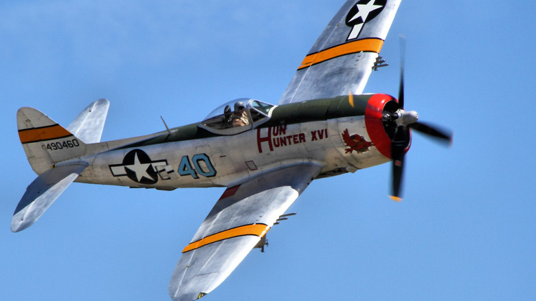 WWII era P-47 Thunderbolt fighter plane flying at air show