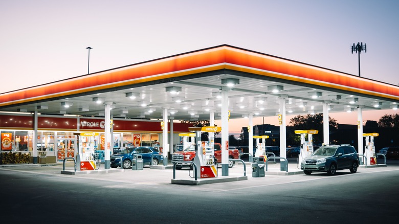 Gas station at night with several cars filling up