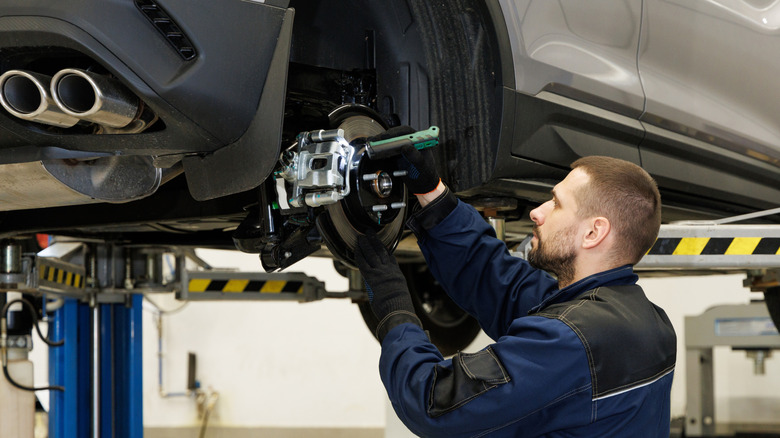 Mechanic changing a car's brake pads