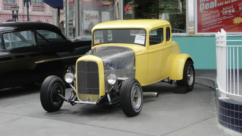 Yellow 1932 Ford Coupe hot rod parked at drive-in