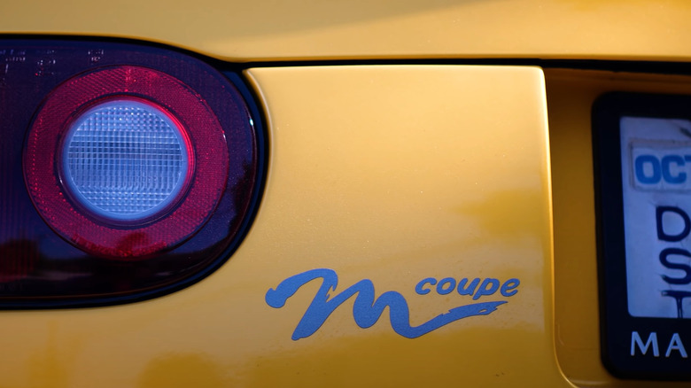 Close up of Mazda M Coupe logo