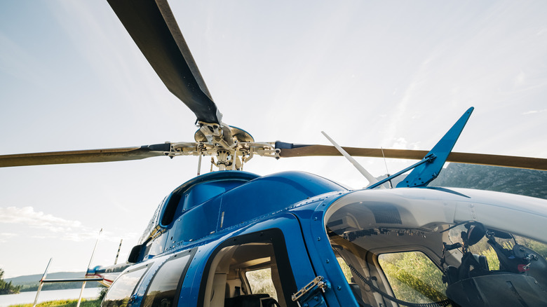 Looking up at the main rotor of a Bell 407 GXI helicopter early in the morning