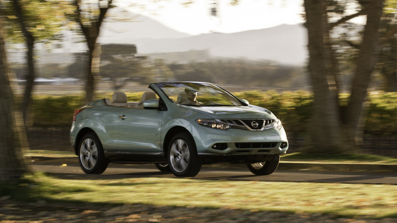 2011 Nissan Murano CrossCabriolet driving down a road at sunset