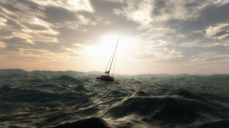 A small sailing yacht stopped in rough seas