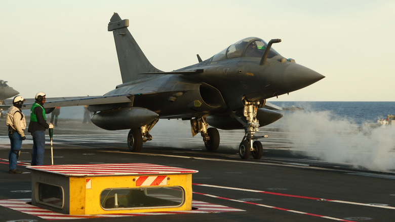 A Dassault Rafale M fighter aircraft is prepared for a launch with the steam catapult
