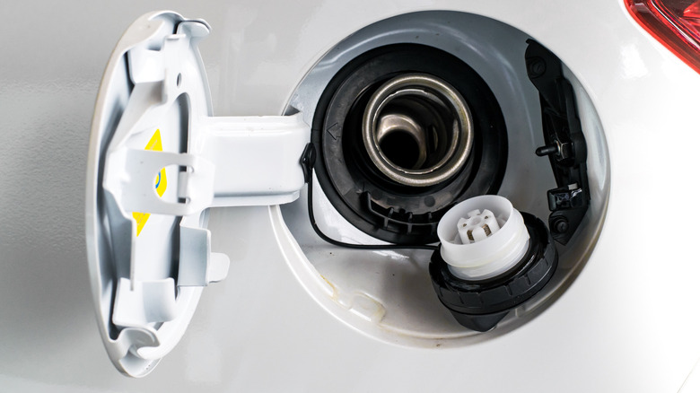 Open gas cap on white car