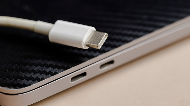 Close-up of USB-C cable alongside laptop