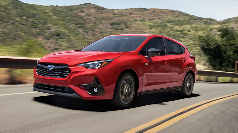 Front left shot of red Subaru Impreza wagon on mountain road
