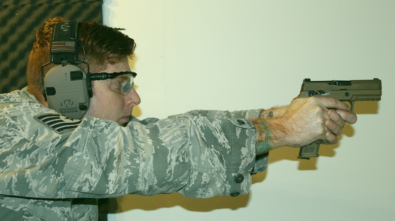 Airman fires M18 with 21-round magazine inserted