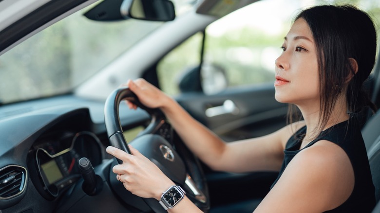 A young woman driving a car
