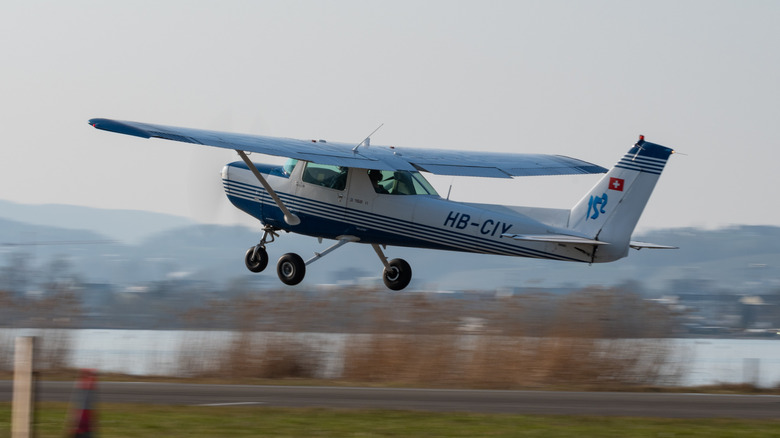 Cessna 152 aircraft taking off from runway