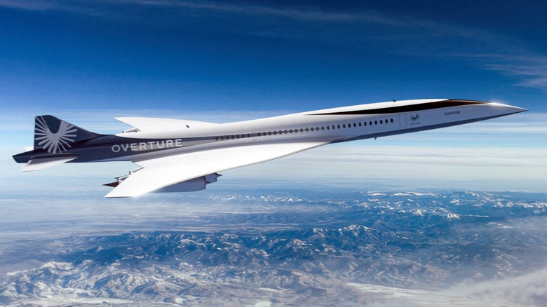 A mockup of a Boom Overture flying over mountains