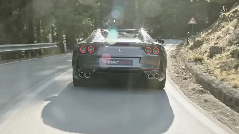 Rear shot of a gray Ferrari 812 GTS on a mountain road