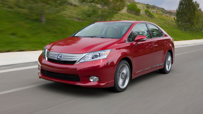 Red Lexus HS 250h driving on road