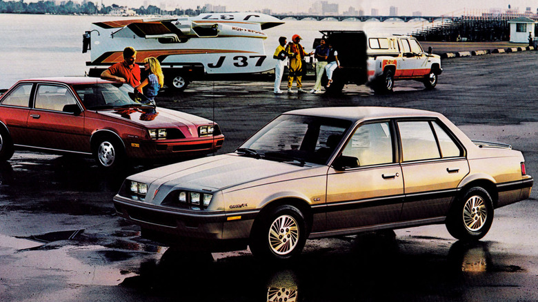 Pontiac 2000 brochure advertisement showing two 2000 models, coupe in background and sedan in foreground