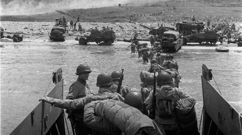 U.S. troops wade ashore from a LCVP landing craft, off 